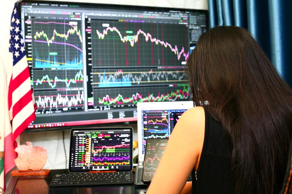 Person analyzing financial charts on a tablet